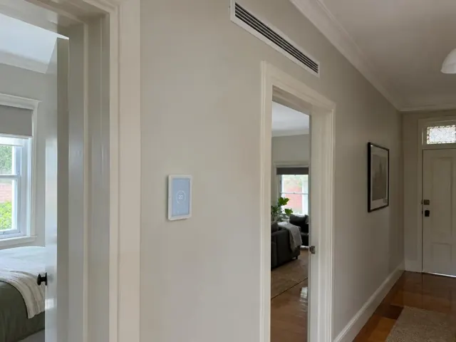 Wall touch controller and narrow ceiling air grille in a hallway with adjoining rooms in Broadview